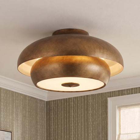 A transitional bedroom featuring a vintage gilded brass Garnett semi-flush mount on a standard ceiling above olive green striped wallpaper and a linen window shade.