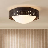 A transitional foyer with an Egan Medium Flush Mount featuring an Urban Bronze perforated band and frosted glass dome above striped beige wallpaper and white crown molding.