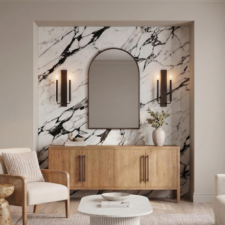 A contemporary living room with two Solana Double Wall Sconce 18", Aged Iron fixtures flanking an arched mirror on a marble feature wall above a wood sideboard.