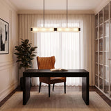 A transitional home office featuring the Enders LED Linear Pendant 47", Urban Bronze and Clear Ribbed Glass suspended over a dark desk and leather chair.