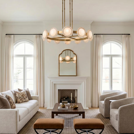 A transitional living room featuring the Osmund LED Chandelier 50 inch, Vintage Brass and Alabaster, centered above a walnut coffee table and white mantel fireplace.