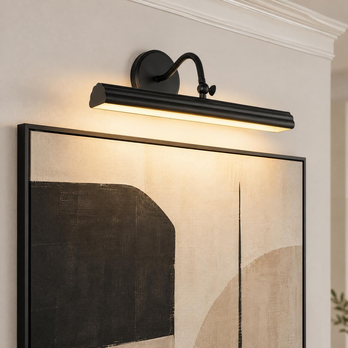 A transitional living room wall featuring the Jacob LED Picture Light 18-inch in Matte Black mounted above a large framed abstract canvas under white crown molding.