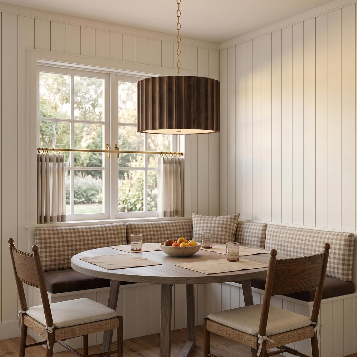 A farmhouse dining nook with the Riverton Large Pendant 26", Espresso and Matte Brass over an oak table near a gingham banquette and shiplap walls.