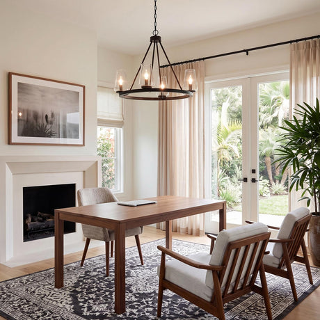 A transitional home office featuring the Darlene 4 Light Chandelier 28", Matte Black suspended over a wooden desk near mid-century armchairs and a fireplace.