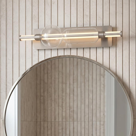 A modern bathroom with the Latimer LED Vanity Light 26", Satin Nickel and Clear Glass installed above a round mirror on a vertical fluted wall.