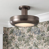 A traditional foyer with the Imara Medium LED Semi-Flush 16 in pewter bronze and ribbed glass mounted to a ceiling with white crown molding and landscape wallpaper.