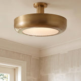 A transitional foyer with an Imara Large LED Semi-Flush in antique brass featuring ribbed glass over textured cream wallpaper and white crown molding.