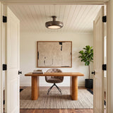 A transitional office featuring the Imara Large LED Semi-Flush 22", Pewter Bronze on a white shiplap ceiling above a wood desk and textured wall art.