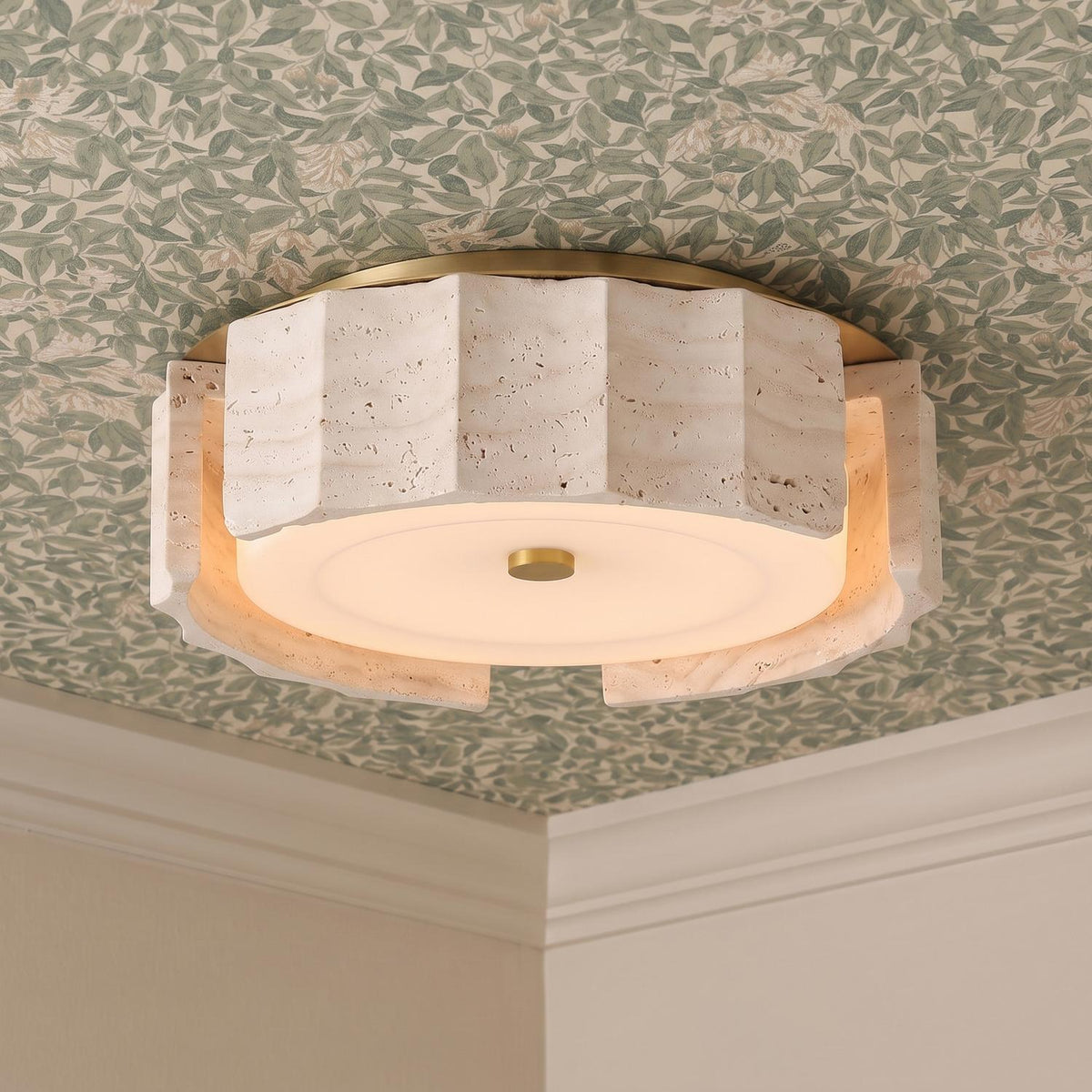 A transitional foyer with the Damari Small LED Flush Mount 12 inch in travertine and brushed brass installed on a green botanical wallpapered ceiling with crown molding.