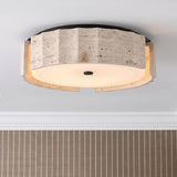 A modern foyer with the Damari Medium LED Flush Mount in travertine and matte black along the ceiling above vertical striped tan wallpaper and white molding.