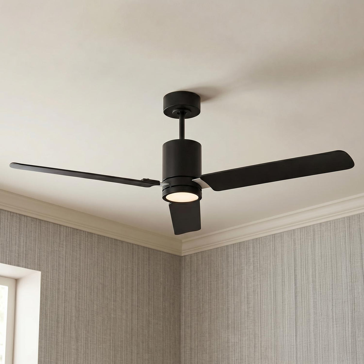 A modern living room with the Corvo LED Ceiling Fan 62 in Matte Black and frosted glass installed along the ceiling center above textured gray wallpaper.