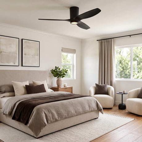 A contemporary bedroom with the Avocet LED Ceiling Fan in matte black oak mounted to the center ceiling above neutral bedding and cream bouclé chairs.