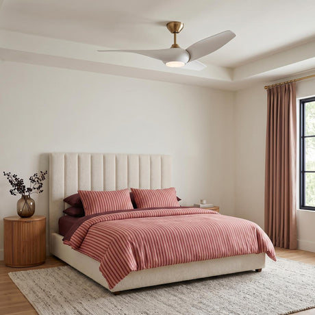 A modern bedroom with the Krestel LED Ceiling Fan 52", Matte White and Modern Brass centered on the ceiling above a cream channel-tufted headboard and terracotta bedding.