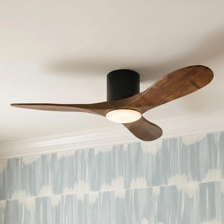A mid-century bedroom with the Eider LED Ceiling Fan 44 inch in walnut wood and matte black mounted to a ceiling above blue patterned wallpaper.