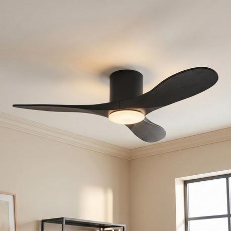 A modern living room with the Eider LED Ceiling Fan 44", Matte Black Oak featuring three matte black oak blades and an integrated frosted glass light.