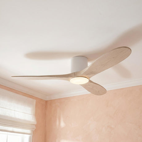 A contemporary bedroom with the Eider LED Ceiling Fan 52", Matte White Oak featuring matte white housing and natural oak blades against textured peach walls.