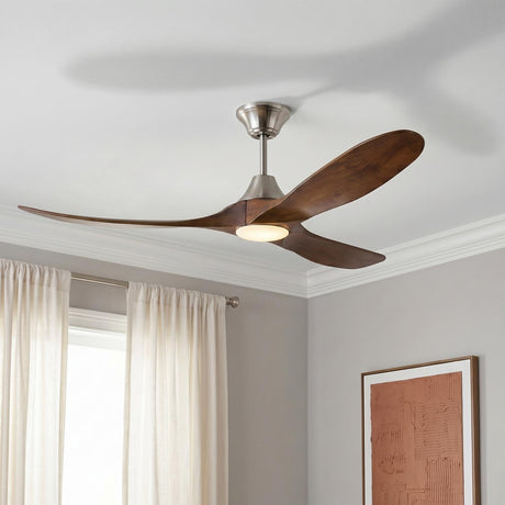A contemporary living room featuring an Egret LED Ceiling Fan 60", Walnut Wood and Brushed Steel mounted on the ceiling with white curtains and framed wall art.
