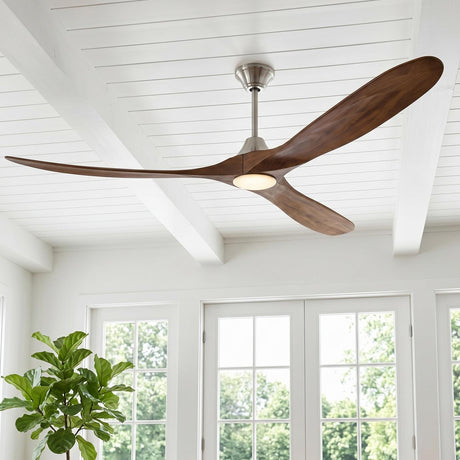 A modern farmhouse living room featuring the Egret LED Ceiling Fan 70", Walnut Wood and Brushed Steel, mounted on a white beamed shiplap ceiling near glass doors.