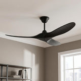 A modern living room with the Egret Ceiling Fan 52" featuring a matte black finish and oak blades installed in the ceiling center near a minimalist bookshelf.