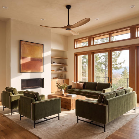 A modern living room featuring Egret Ceiling Fan 60", Natural Oak and Matte Black with natural oak blades installed above olive green velvet sofas and a modern fireplace.