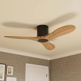 A mid-century bedroom featuring an Eider Ceiling Fan with natural oak blades and matte black motor housing mounted in the ceiling center above textured gray grasscloth wallpaper.
