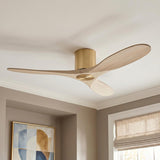 A contemporary living room featuring the Eider Ceiling Fan 52", Whitewash Oak and Modern Brass mounted to a white ceiling above beige walls and geometric art.