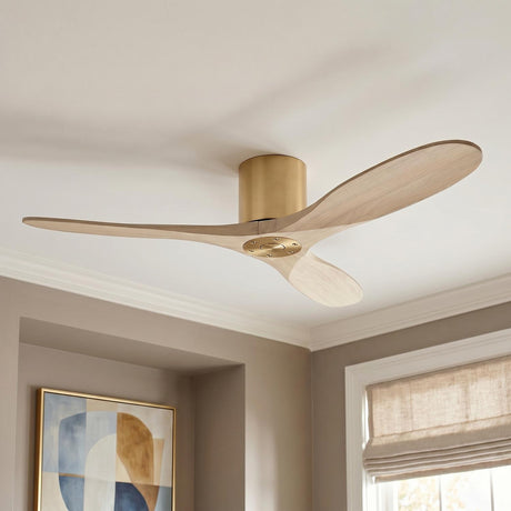 A contemporary living room featuring the Eider Ceiling Fan 52", Whitewash Oak and Modern Brass mounted to a white ceiling above beige walls and geometric art.