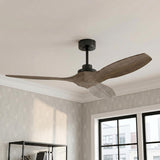 A transitional office featuring a Heron Smart Ceiling Fan with gray wash oak blades and aged pewter finish above a black metal bookshelf and patterned wallpaper.