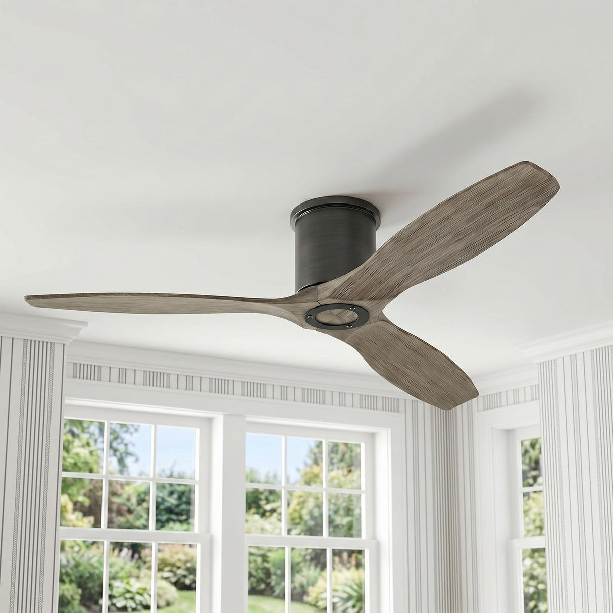 A transitional living room with a Harrier Smart Ceiling Fan 52", Gray Wash Oak and Aged Pewter mounted to the ceiling center near striped wallpapered walls.