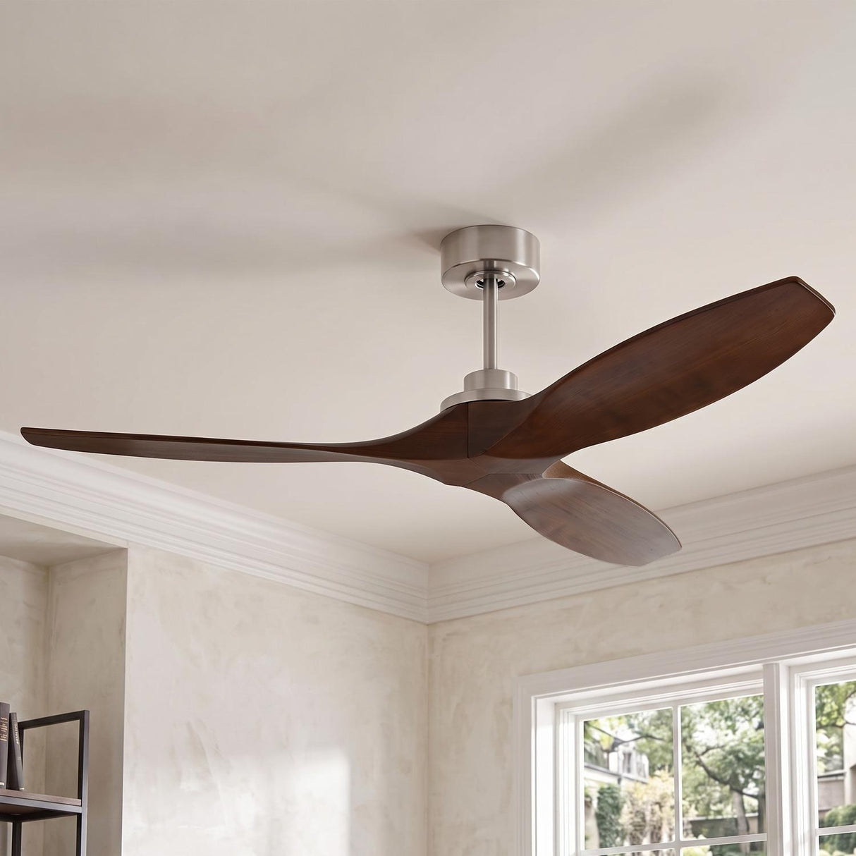 A mid-century living room with the Heron Smart Ceiling Fan 60" in walnut wood and brushed steel mounted on a standard ceiling with white crown molding.