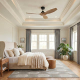 A transitional bedroom featuring the Heron Smart Ceiling Fan 52", Natural Oak and Matte Black mounted to a coffered ceiling center above a beige wingback bed.