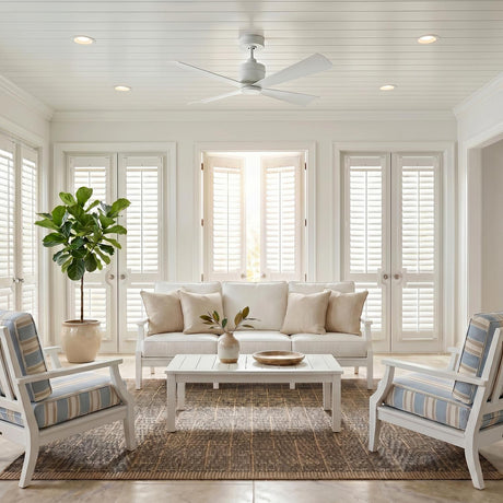 A coastal living room featuring the Sora Ceiling Fan 44", Matte White mounted on a white shiplap ceiling above a white sofa and a fiddle leaf fig.