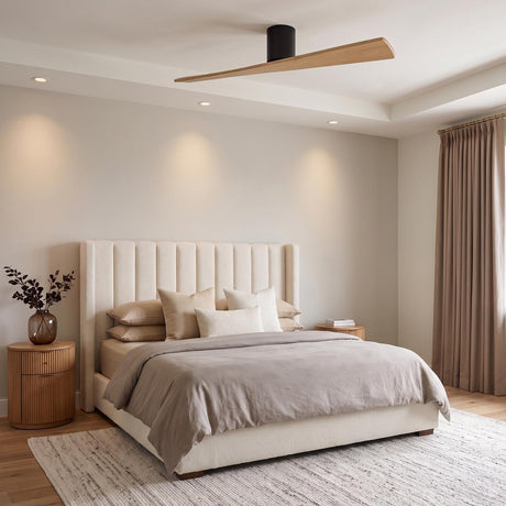 A modern bedroom featuring the Finch Smart Ceiling Fan 52", Natural Oak and Matte Black above a beige tufted upholstered bed and fluted wood nightstands with neutral linens.