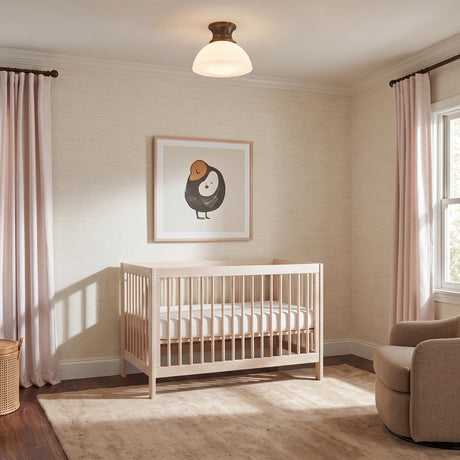 A transitional bedroom featuring a Lennox Medium Semi-Flush 16 inch Vintage Bronze and Milk Glass fixture above a light wood crib and pink curtains.
