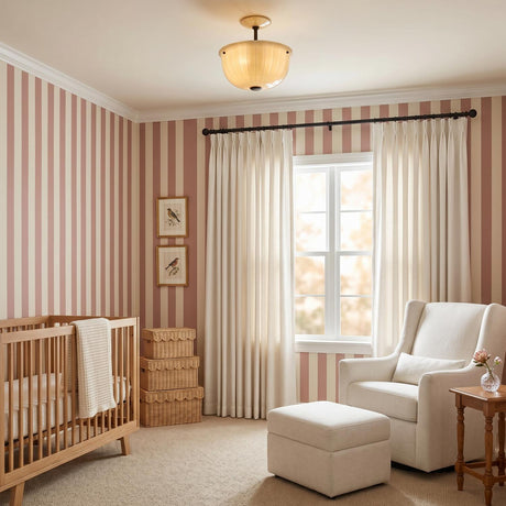 A traditional bedroom with the Cortland Semi-Flush in champagne glass and distressed bronze at the ceiling center, featuring pink striped wallpaper and a light wood crib.