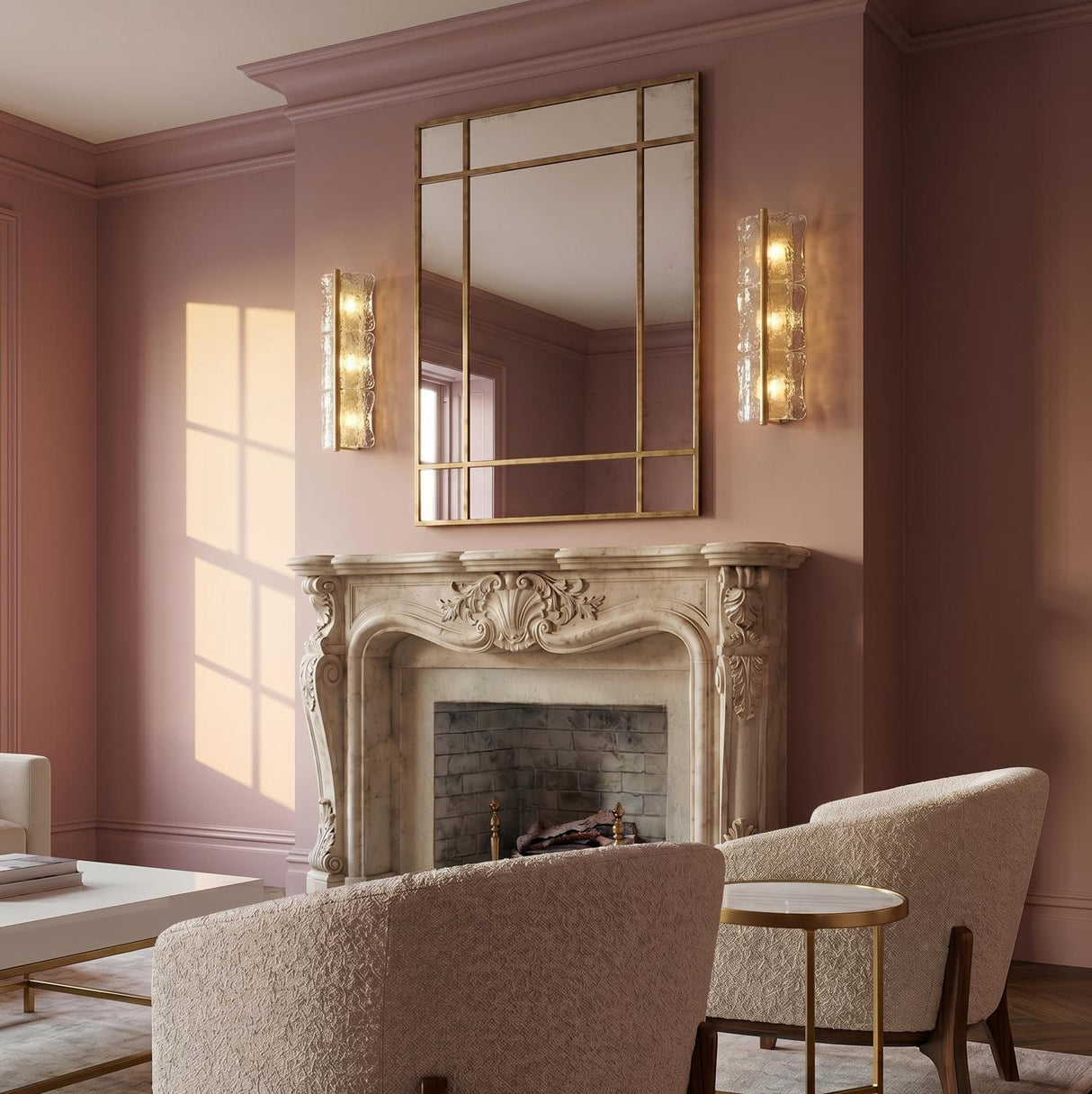 A traditional living room featuring the Bristolia 3 Light Wall Sconce in aged brass and clear piastra glass flanking a mirror above a marble fireplace.