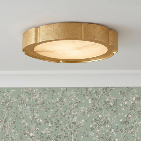 A traditional foyer with a gold leaf and alabaster flush mount on a white ceiling above sage green floral wallpaper and white crown molding.