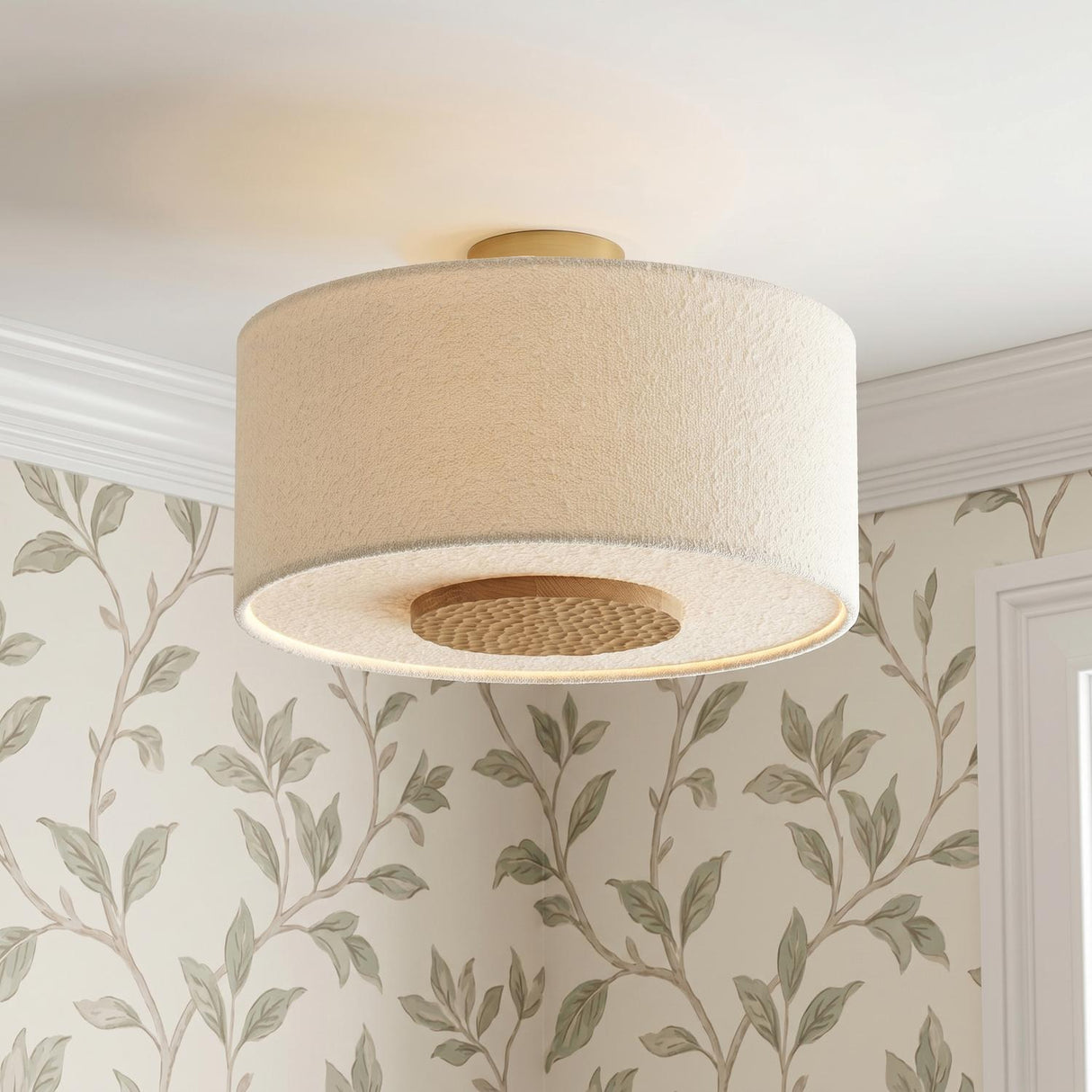 A traditional bedroom featuring the Wolfe Medium Semi-Flush in ivory boucle, aged brass, and beech wood on the ceiling center beside beige floral wallpaper and white molding.