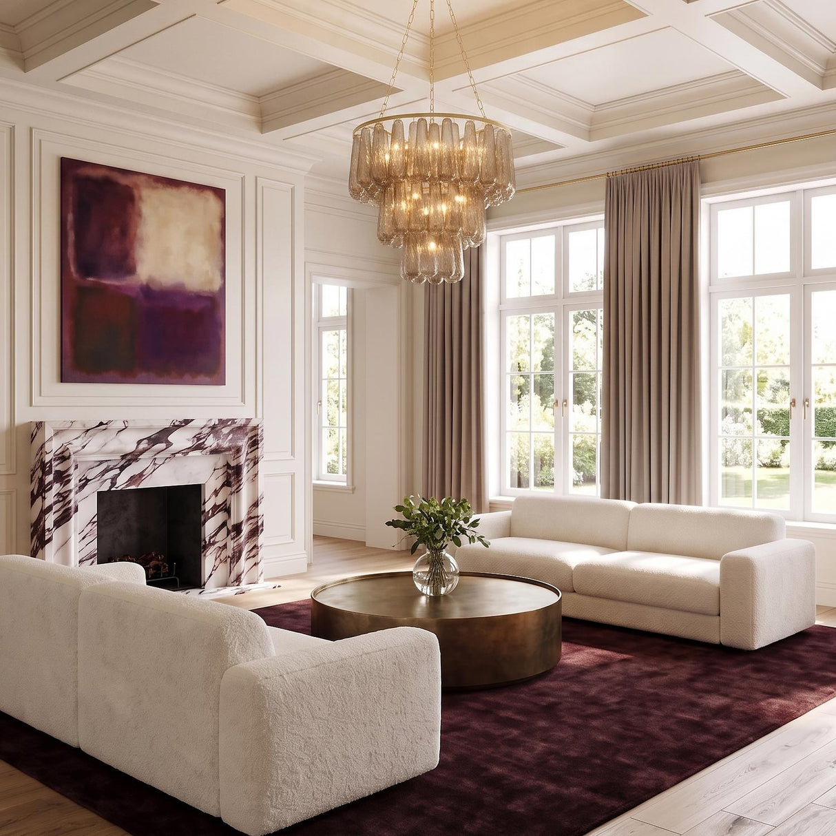 A contemporary living room featuring the Petronella Three-Tier Chandelier with smoke taupe swirled glass centered on a white coffered ceiling above white sofas and a marble fireplace.