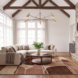 A modern farmhouse living room featuring the Ralph 5 Light Chandelier in vintage brass and soft sand suspended from a vaulted beamed ceiling above a cream sectional.