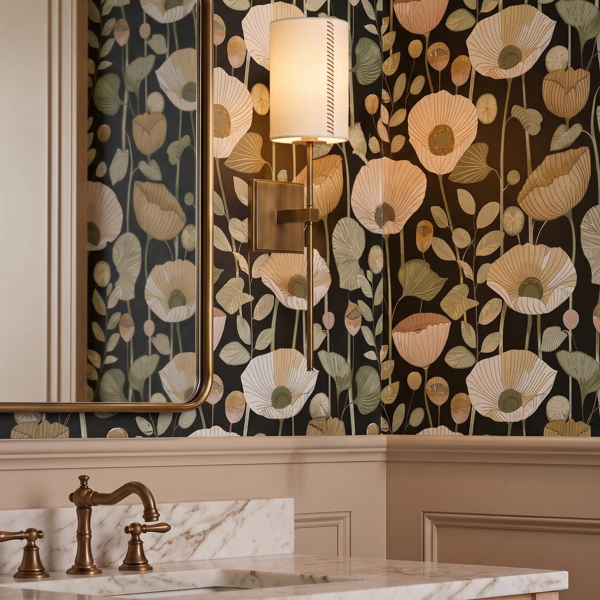 A traditional bathroom with a patina brass wall sconce featuring a linen shade mounted on floral wallpaper beside a brass-framed mirror and white marble vanity.
