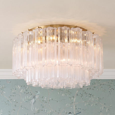 A transitional foyer with the Grace Flush Mount 22", Brass with Clear Glass featuring textured rods along a standard ceiling above blue bird-themed chinoiserie wallpaper.