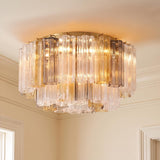 A transitional foyer with the Grace Flush Mount 22 inch, Brass with Gilded Fog Glass installed on a standard ceiling with white crown molding and cream walls.