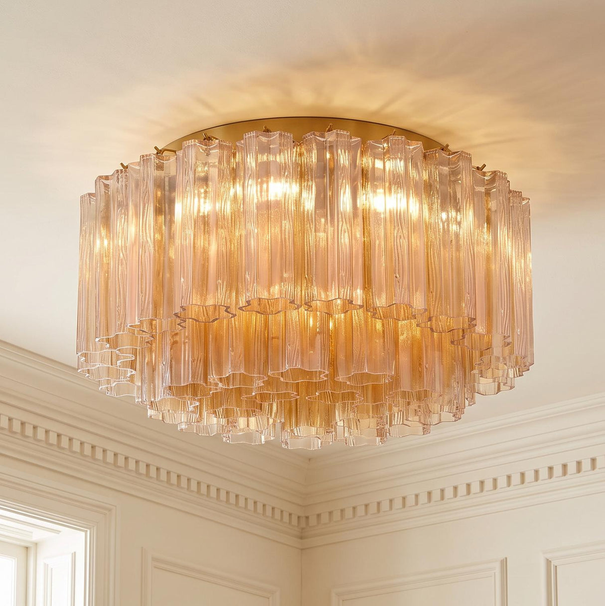 A traditional foyer with the Grace Flush Mount 22-inch, Brass with Topaz Glass installed on a standard ceiling with white dentil crown molding and decorative wall panels.