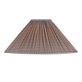 A pleated fabric lampshade with a brown and beige gingham checkered pattern, shown against a plain white background.