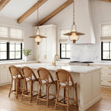 A modern farmhouse kitchen with two Leonel Medium Pendants in patina brass and seeded cloud glass over a white marble island under a vaulted beamed ceiling.