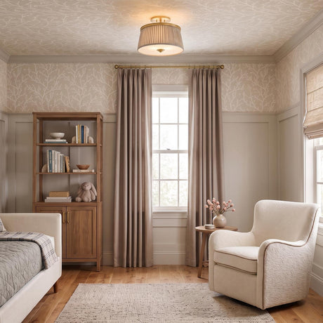 A transitional bedroom with the Wilma Semi-Flush 16 in aged brass and taupe print along the ceiling center above a cream armchair and botanical wallpaper.
