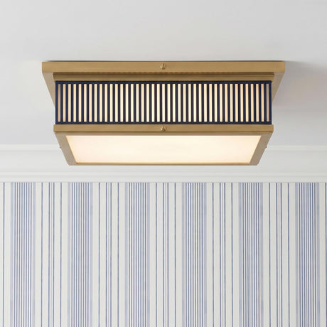 A transitional foyer with the Hawthorne Square LED Flush Mount in aged brass and midnight blue along the ceiling with blue pinstripe wallpaper and white crown molding.