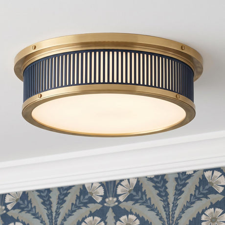 A transitional foyer with the Hawthorne Round LED Flush Mount 14", Aged Brass and Midnight Blue along the ceiling center with blue floral patterned wallpaper.