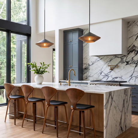 A modern kitchen featuring two Sunita Medium Pendants in matte black and rope hanging over a white marble waterfall island under a double-height ceiling.